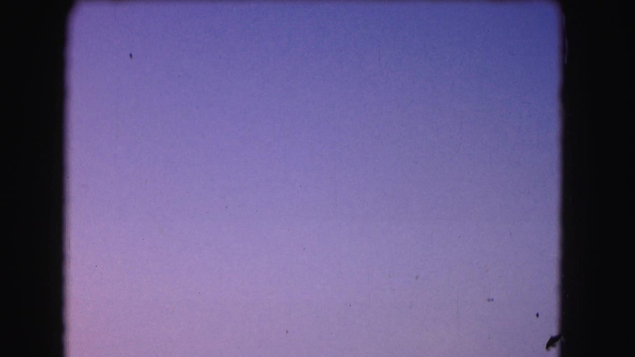 Purple-blue sky gradient framed by dark 8mm film borders.