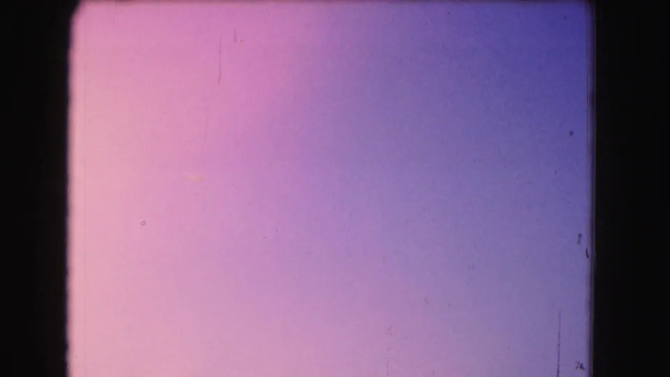 1975 Washington, DC 8mm frame showing a pink-to-purple twilight gradient with grain, edge shadowing, and minor surface marks.