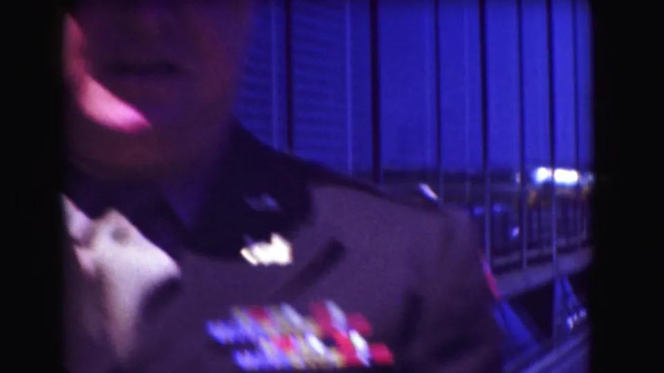 Soft handheld close-up from 1975 Washington DC footage showing part of the man's uniform, collar, and colorful ribbon bars.