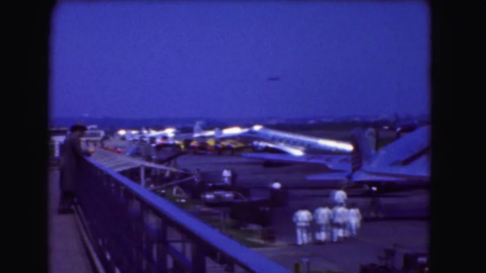 From the viewing platform, the 1975 Washington DC footage shows aircraft on the tarmac with ground crew gathered nearby.