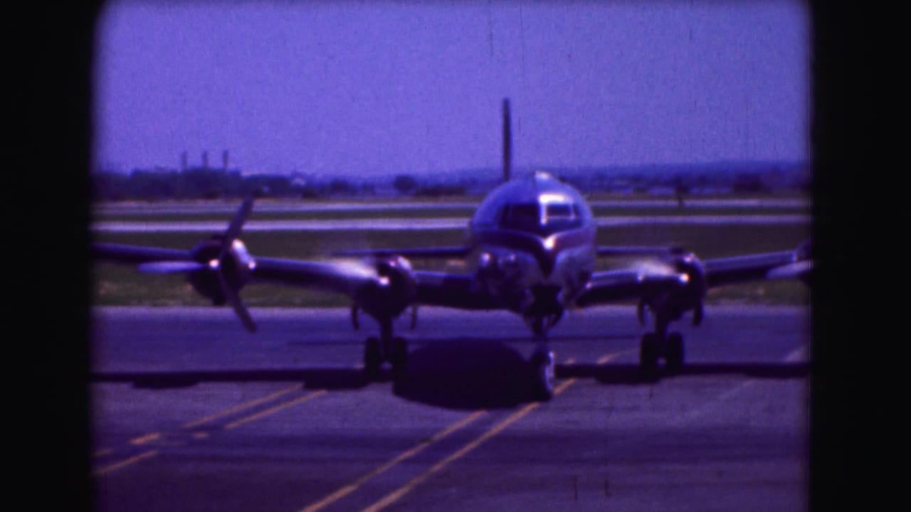 Propeller passenger aircraft centered on the runway with engines turning.