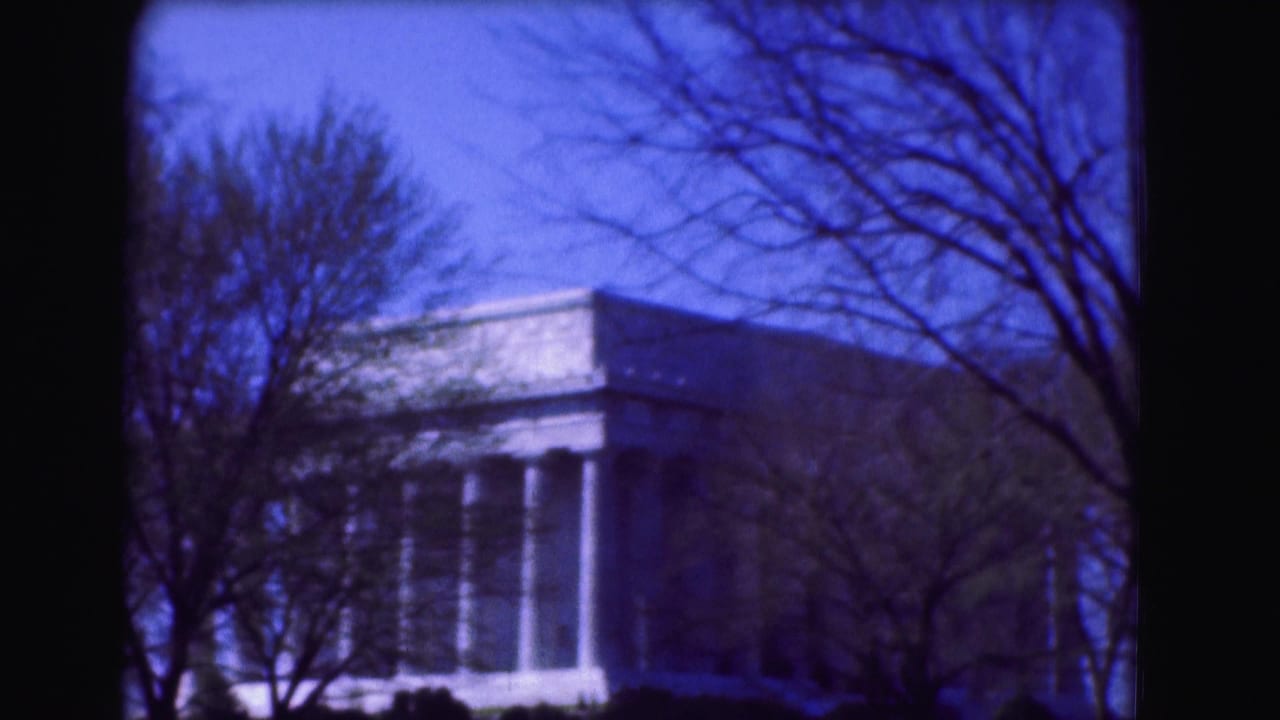 Lincoln Memorial columns and roofline partly obscured by trees.