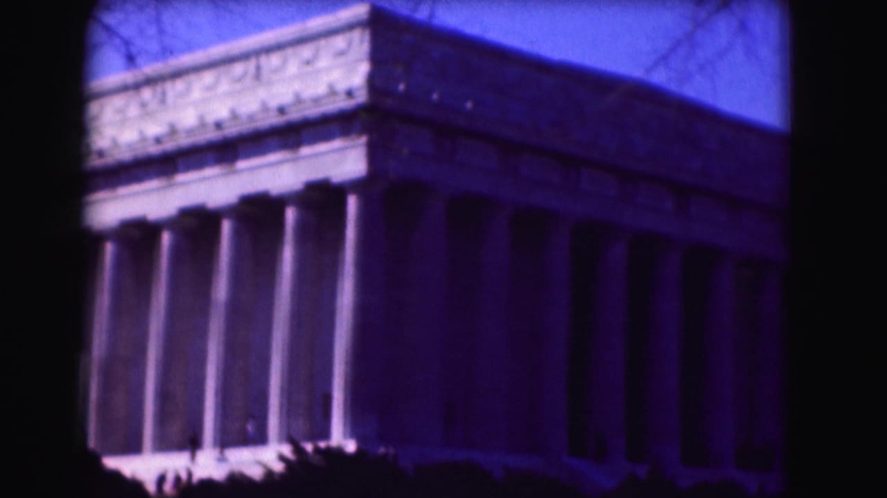 Lincoln Memorial facade with tall columns under a blue-tinted sky.