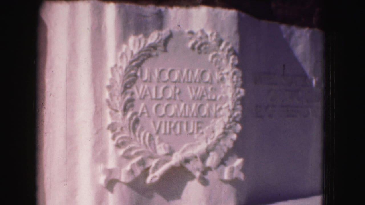Close view of a carved laurel wreath and the inscription Uncommon Valor Was a Common Virtue.