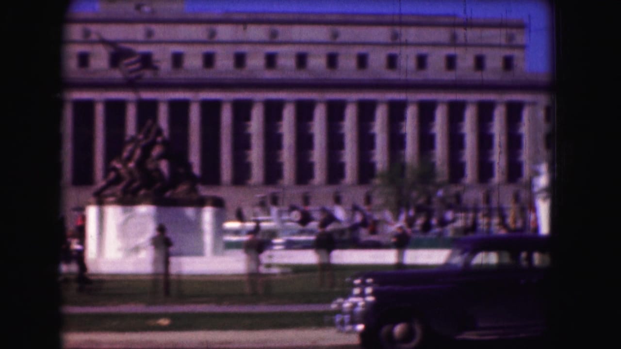 1975 Washington, D.C. view of the Marine Corps War Memorial area with flags, uniformed personnel, visitors, and a period car.