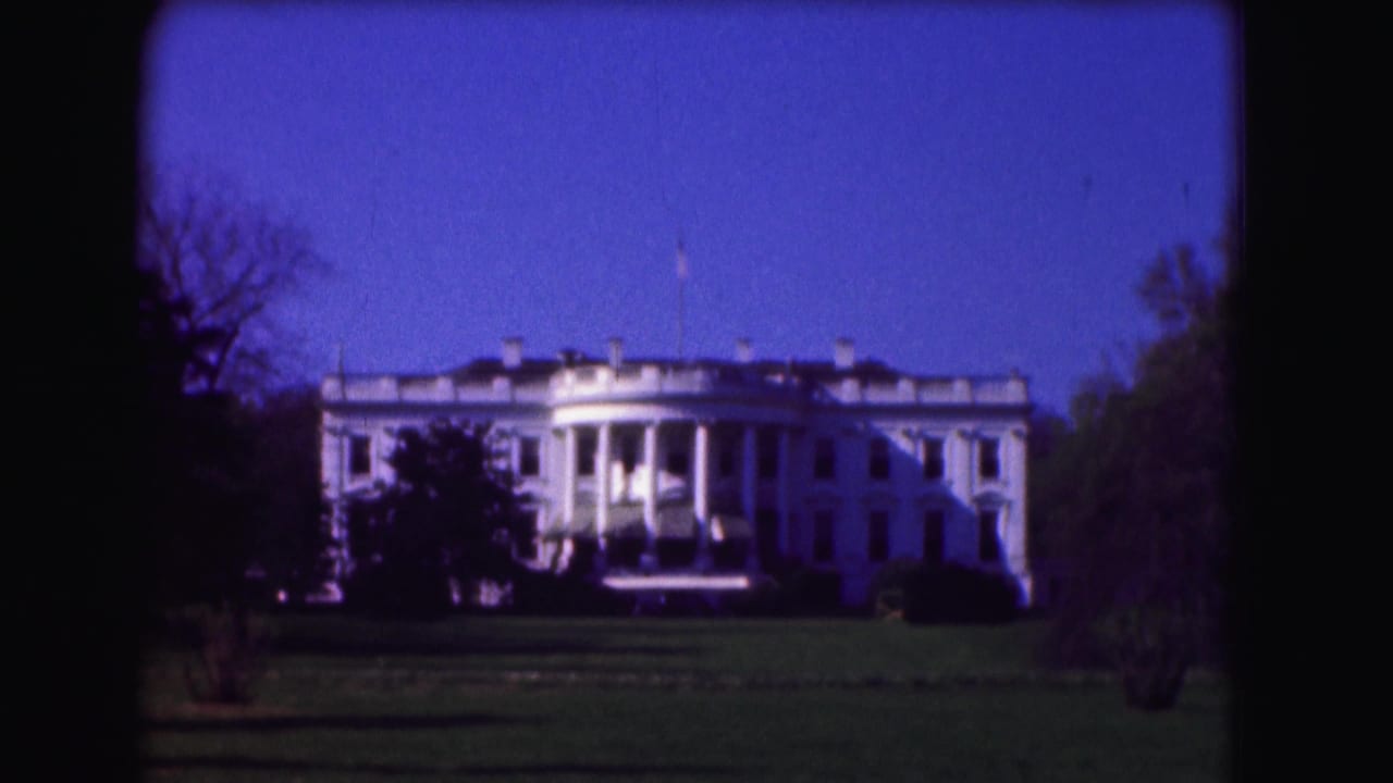 Second 8mm view of the White House in Washington, DC, with the lawn in front and trees on both sides.