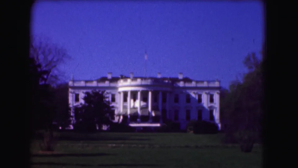 Second 8mm view of the White House in Washington, DC, with the lawn in front and trees on both sides.
