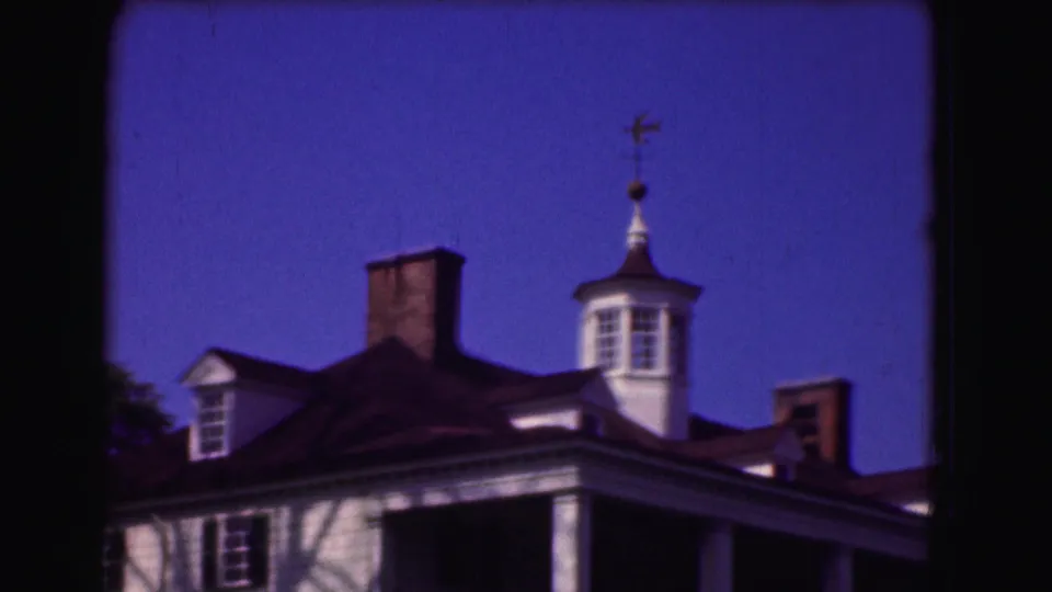 The final frame holds on the house architecture, showing the cupola, chimneys, dormer, and white columns with strong 8mm color shift.
