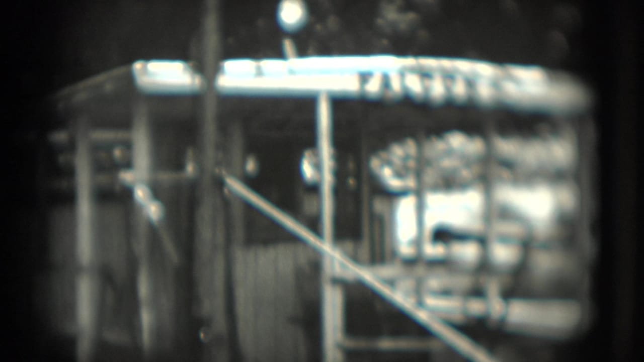 Close view of a barred enclosure with a bright FALCON sign above it.
