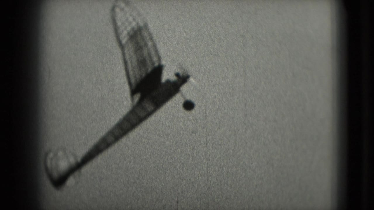 Model airplane climbs against a bright sky after launch.