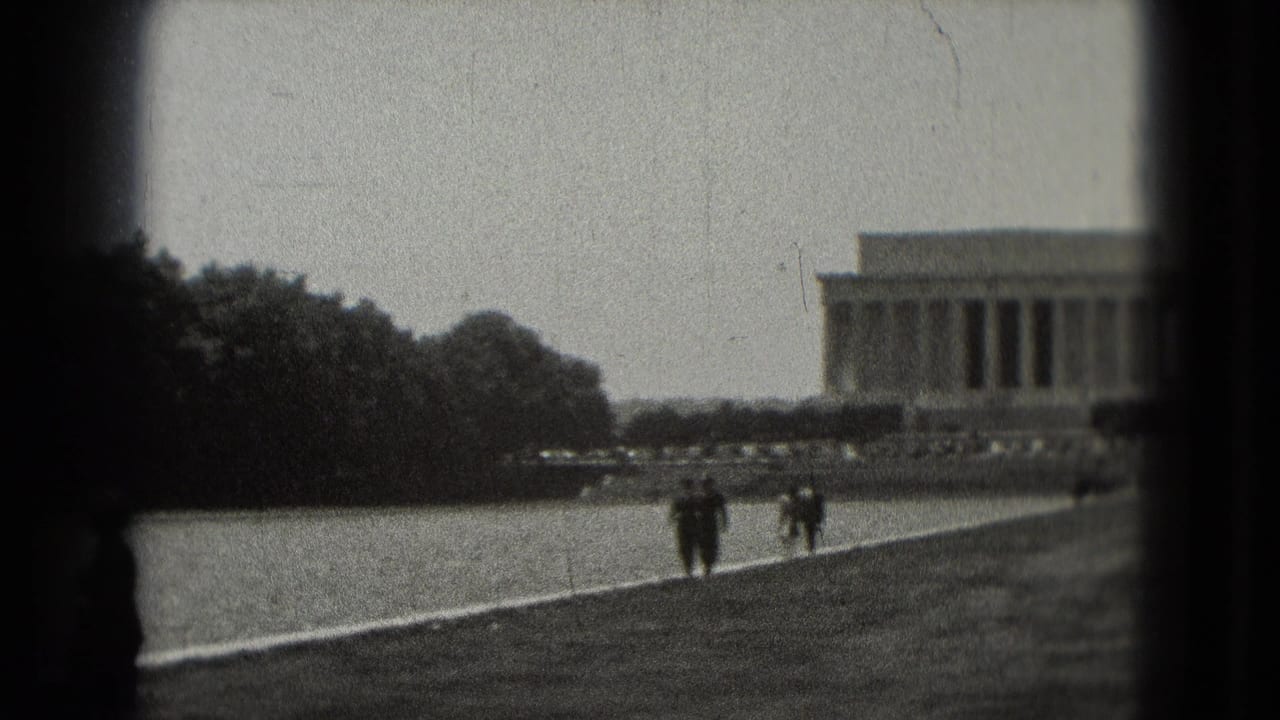 Distant 1975 Washington, DC view of the Lincoln Memorial and Reflecting Pool area, with two tourists walking through the National Mall landscape.