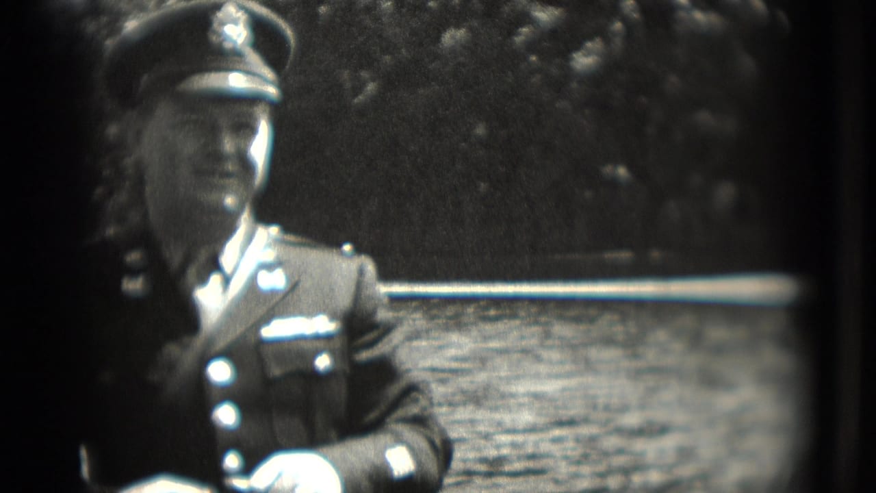 1975 Washington, DC home-movie frame showing a uniformed man in a cap near water and trees.