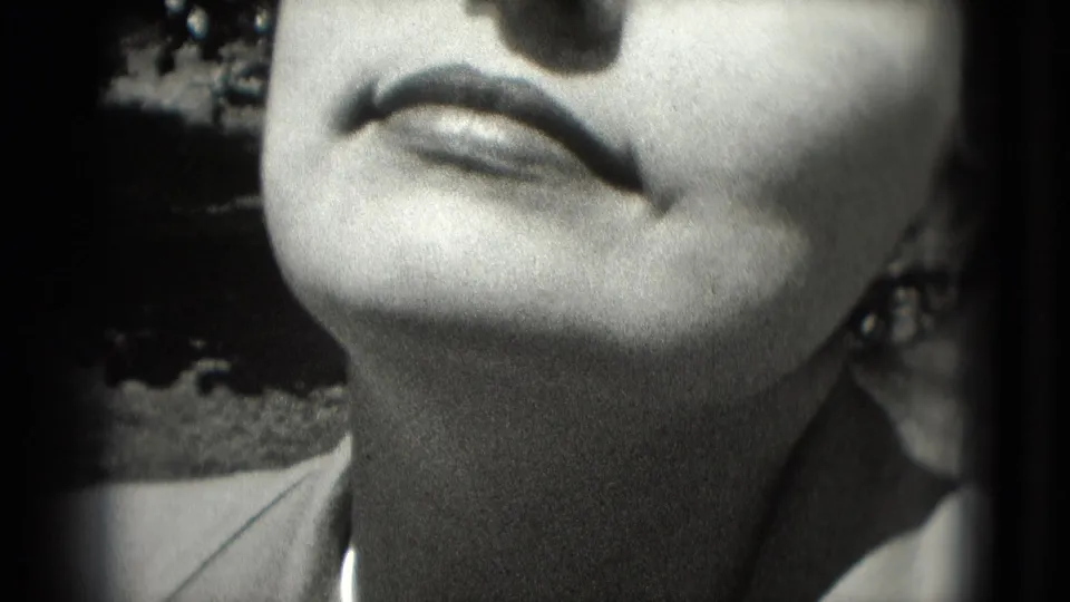 1975 Washington, DC 8mm close-up of an adult woman tilting her face toward sunlight, with lips and closed eyes partly cropped.