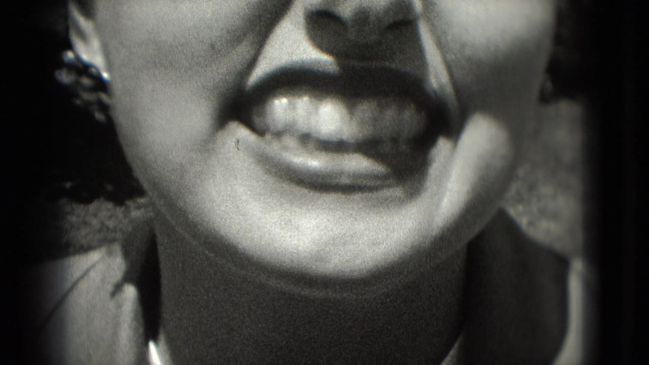 Washington, DC 1975 home-movie close-up of a woman's mouth and chin as she smiles with teeth visible.