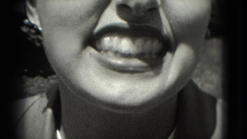 Washington, DC 1975 home-movie close-up of a woman's mouth and chin as she smiles with teeth visible.