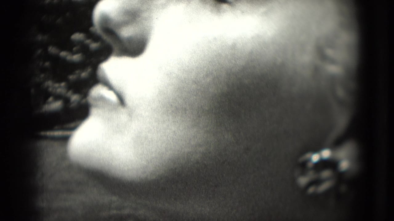 Profile close-up of a woman's face with an earring visible.