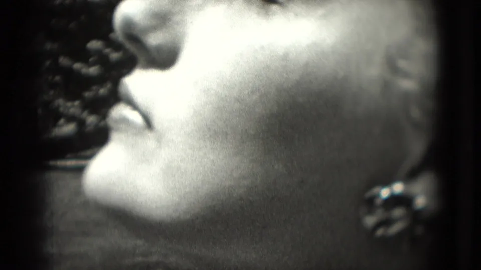Washington, DC 1975 close-up profile of a woman wearing a noticeable earring against a dark background.