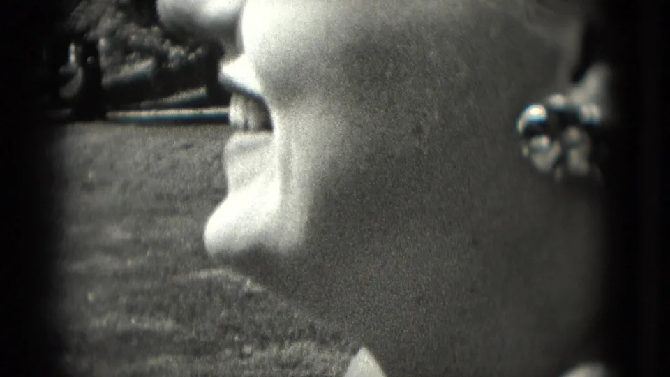 Washington, DC 1975 profile close-up of the woman opening her mouth, with her earring catching light.
