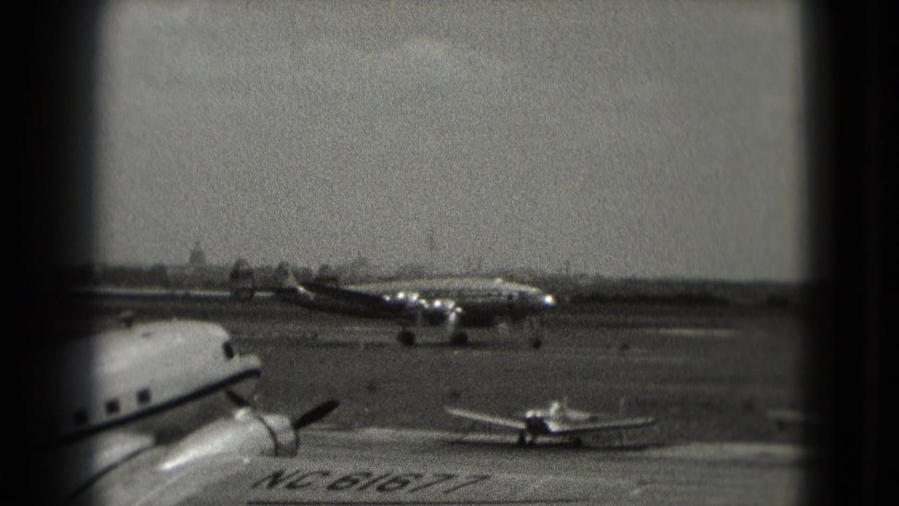 Large propeller aircraft taxiing on a runway near smaller planes on the tarmac.