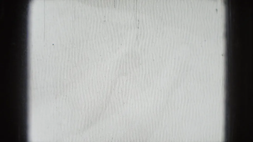 Overexposed opening frame from a 1975 Washington DC 8mm home movie, mostly bright texture with dark film-frame borders.