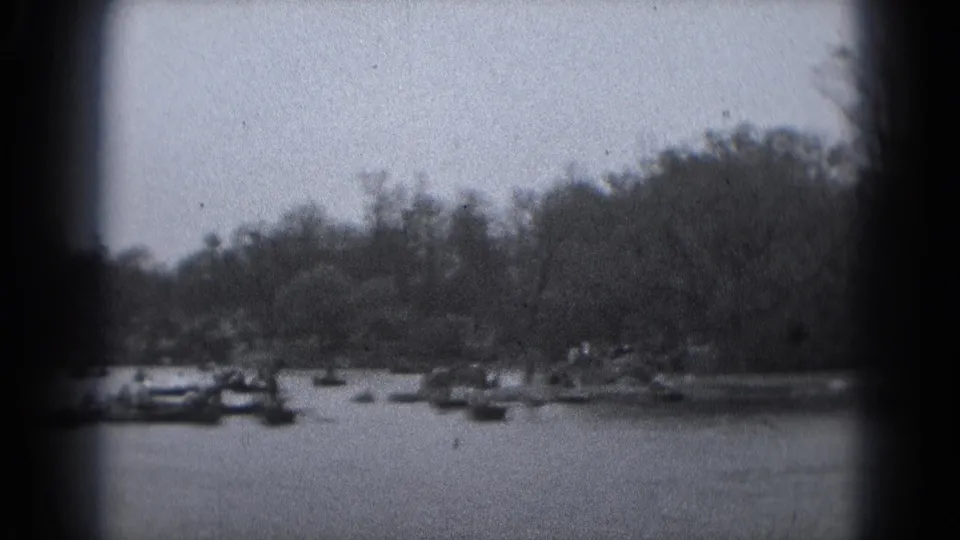 A soft 8mm river view shows small boats on the water with a tree-lined shore in Washington DC metadata context.