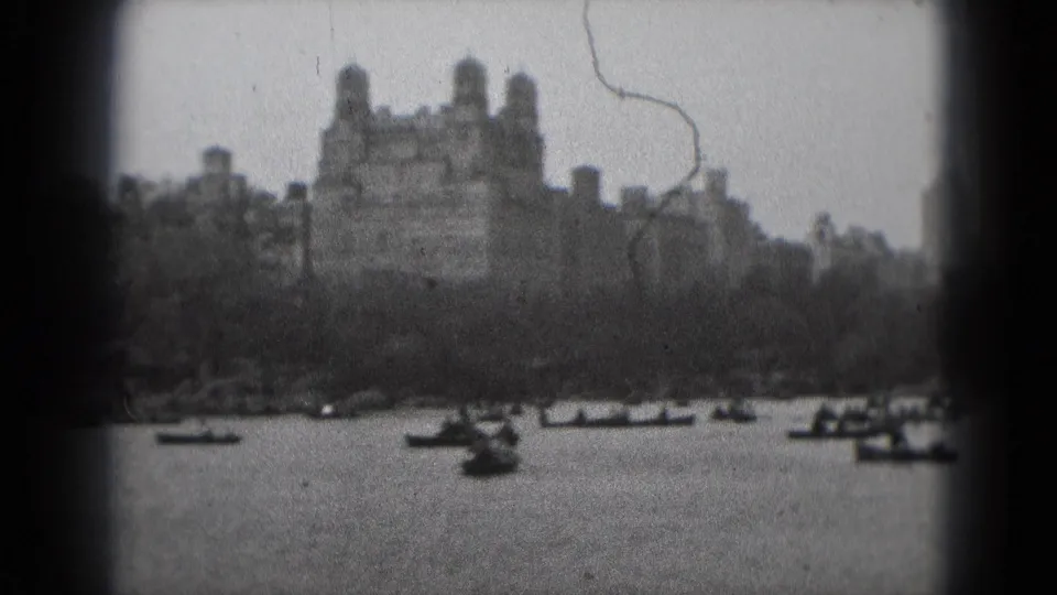 A Washington DC 8mm frame shows small boats on the water and a distant castle-like structure above the shoreline.