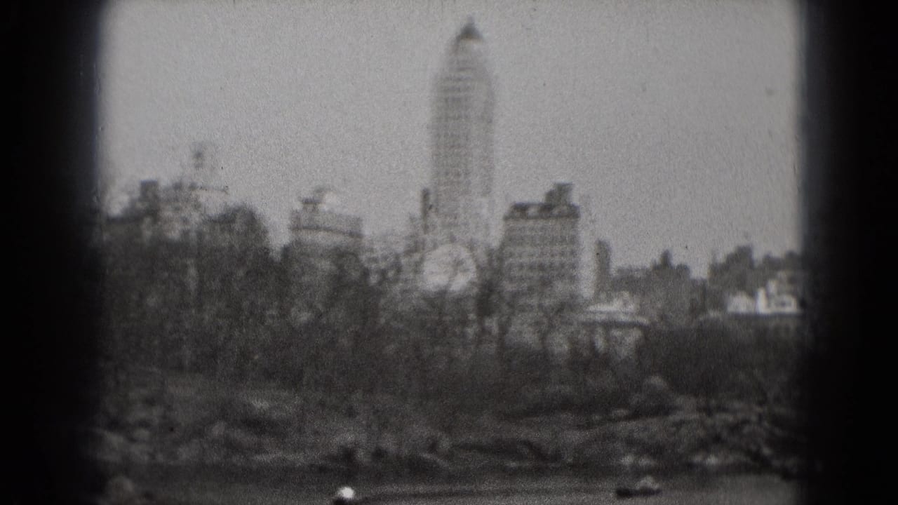 Washington, DC park panorama showing a lake, rowboats, leafless trees, and distant high-rise buildings in 1975 home-movie footage.