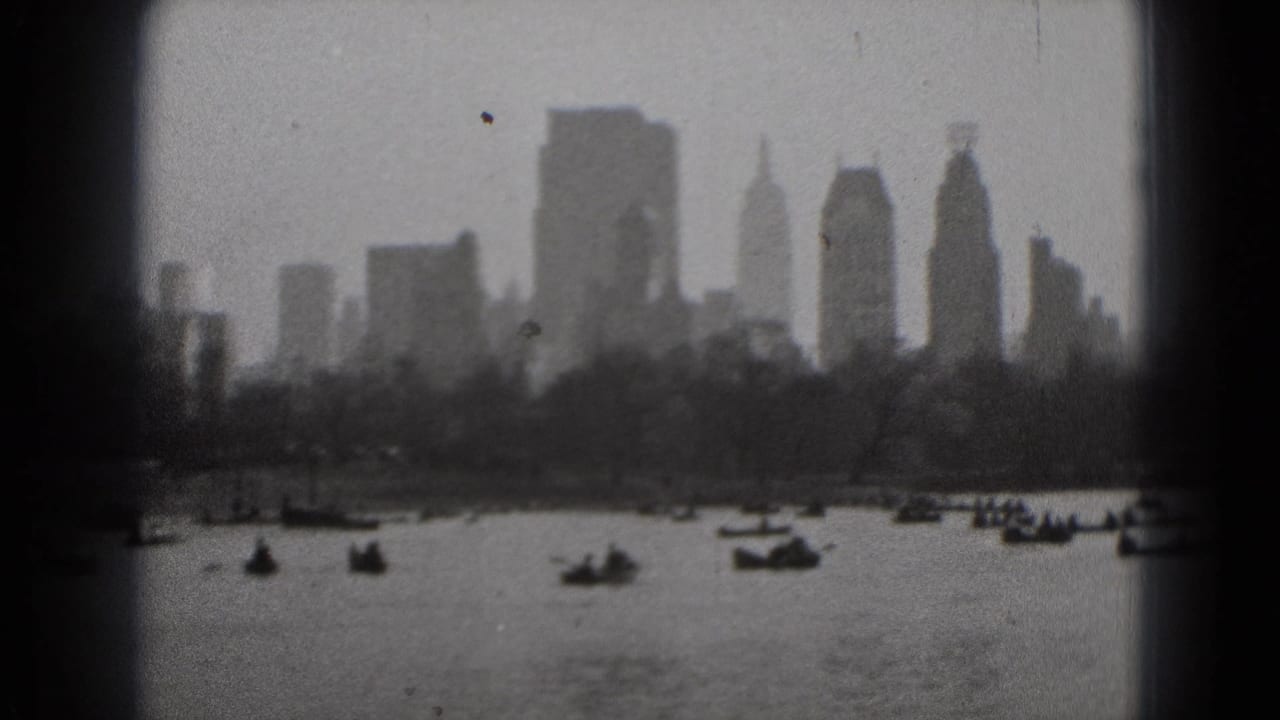 1975 8mm Washington DC view of small boats on water with a distant skyline softened by haze and film grain.