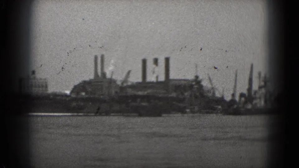 Distant Washington, DC waterfront industry appears across the water, with smokestacks and soft 8mm focus.