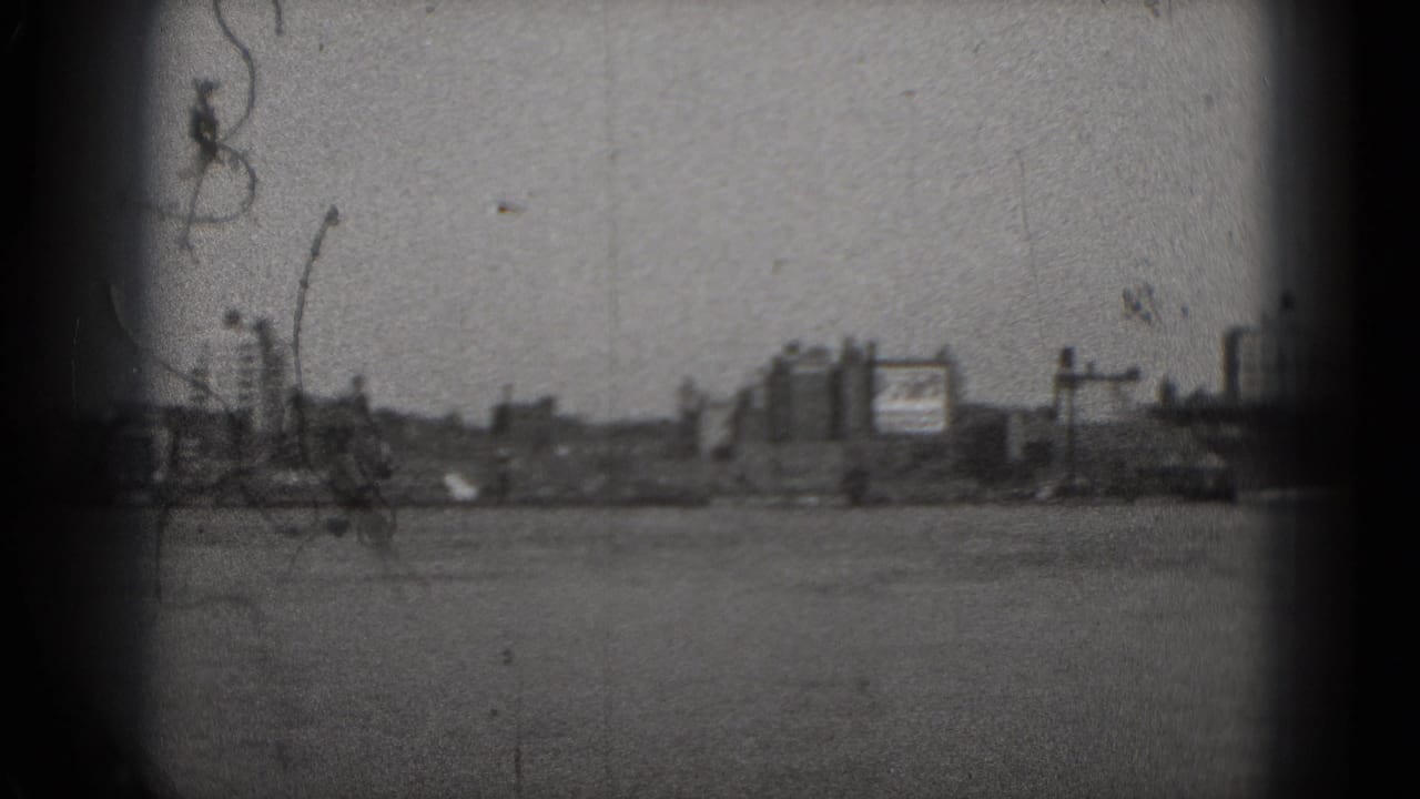 Wide river view with distant buildings and dark 8mm frame edges.