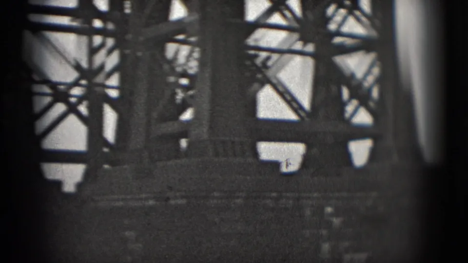 Close 8mm view of bridge lattice, railings, and lower beams in the supplied 1975 Washington, DC footage.