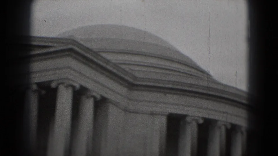 1975 Washington, DC 8mm frame of the Jefferson Memorial dome, entablature, and columns, partly bordered by dark film or camera edges.