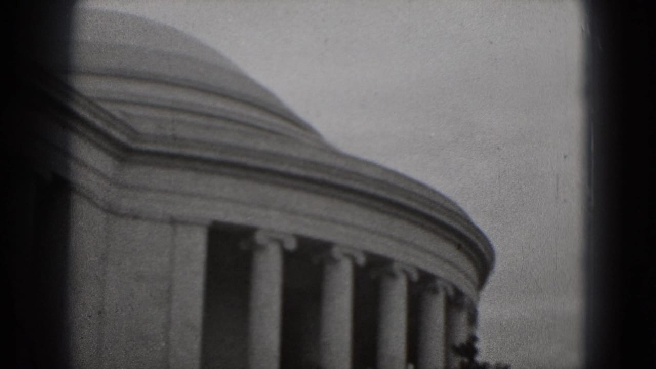 Soft black-and-white view of the Lincoln Memorial roofline and columns.