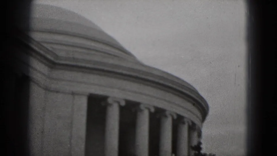 1975 8mm home-movie view of the Lincoln Memorial in Washington, DC, framed close on the roofline and columns.