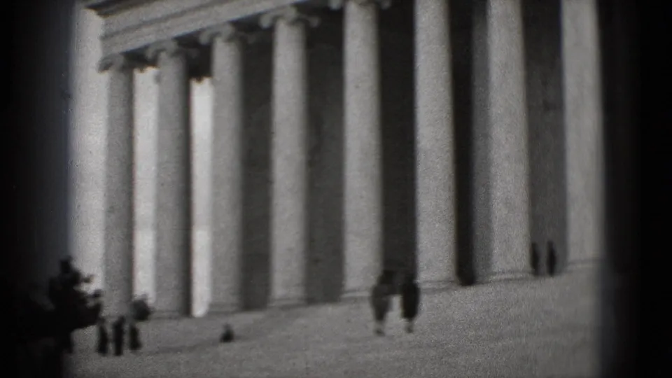 1975 visitor-shot 8mm frame of the Lincoln Memorial steps and columns, with a few small people visible near the entrance.