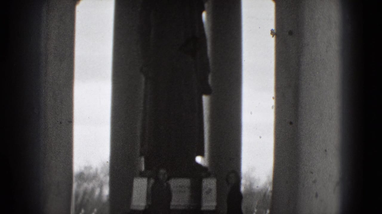 A shadowed statue and classical columns frame a silhouetted visitor in this 1975 Washington, DC monument view.