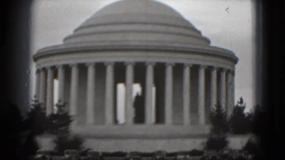 1975 8mm frame of the Jefferson Memorial in Washington, DC, with the dome and columns filling more of the view and trees along the lower edge.