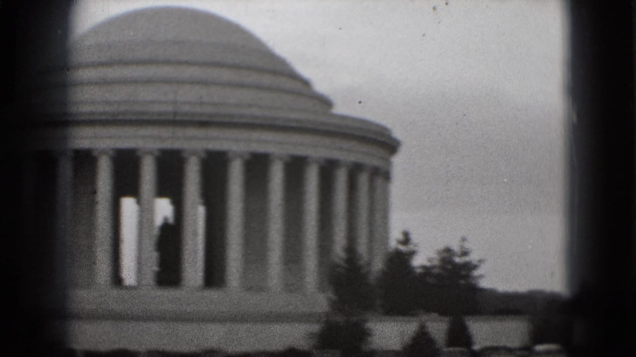 1975 8mm home-movie frame of the Jefferson Memorial in Washington, DC, with dome and columns partly obscured by dark viewfinder borders.