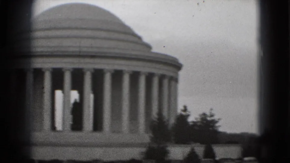 1975 8mm home-movie frame of the Jefferson Memorial in Washington, DC, with dome and columns partly obscured by dark viewfinder borders.