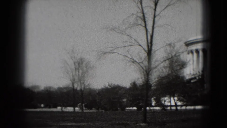 The camera pans across Washington, DC parkland as part of the Jefferson Memorial begins to appear at the right edge.