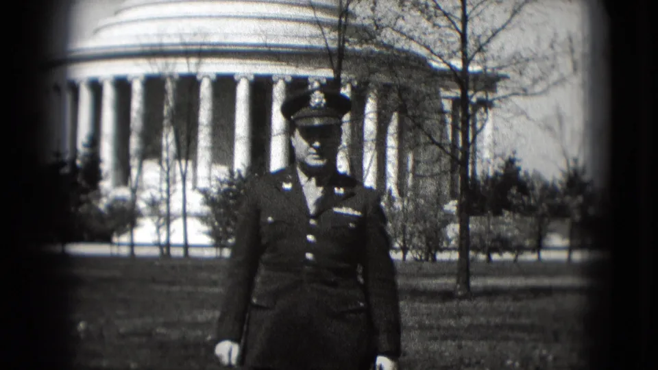 The serviceman fills more of the frame in front of a Washington DC columned landmark, with soft-focus 8mm texture and dark vignette edges.