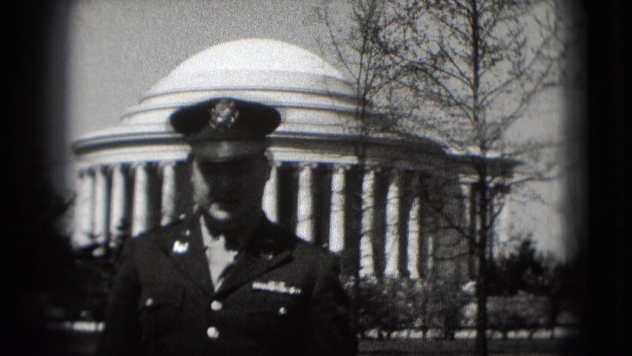 A closer 1975 Washington, DC frame shows a military-uniformed man before the Jefferson Memorial, partly shaded by his cap.