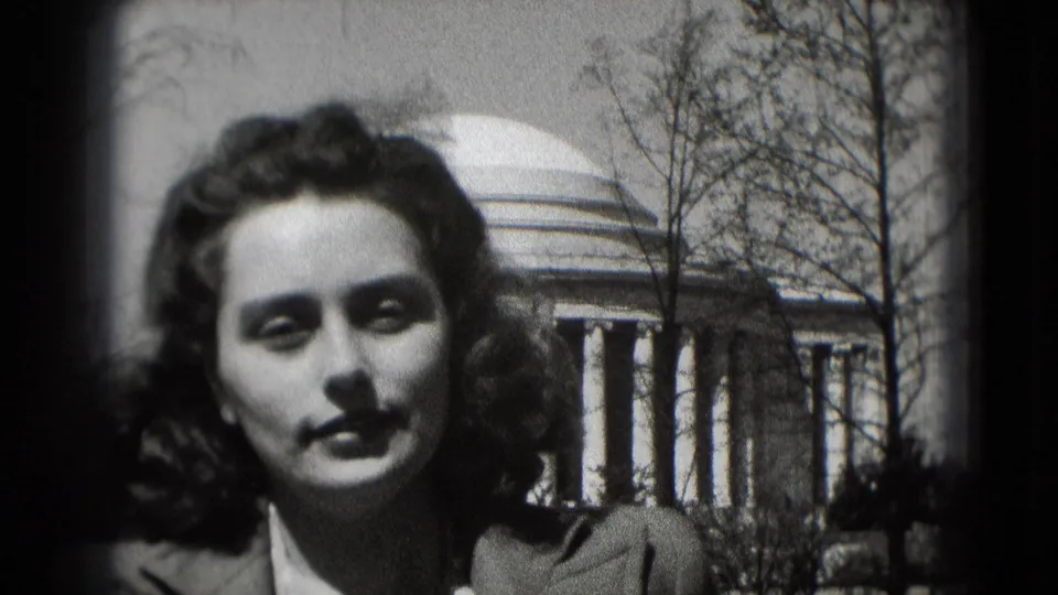 Young woman in 1975 Washington, DC appears outdoors before the Jefferson Memorial, with bare trees and columns behind her.