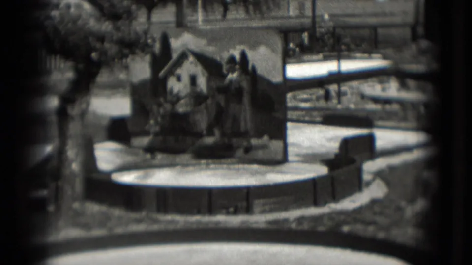A 1975 Washington, DC mini golf obstacle shows a painted house-and-tree backdrop on a circular putting area, filmed in grainy 8mm.