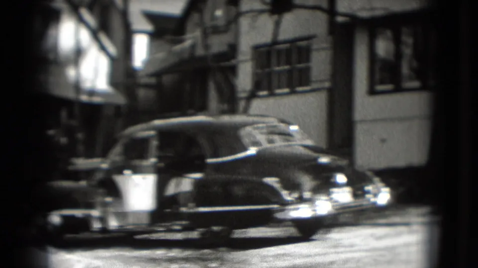The final frame shows a rounded sedan in front of Washington, DC residential buildings, with soft focus and 8mm grain.