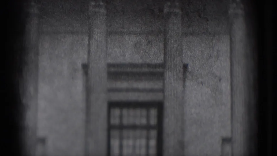 1975 8mm Washington DC footage showing a soft, grainy stone building facade with a rectangular window near the lower center.