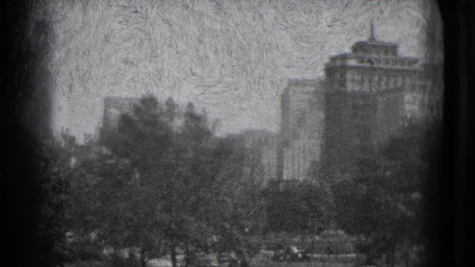 1975 Washington, DC home-movie frame showing trees, distant buildings, and a prominent domed or tiered rooftop form.