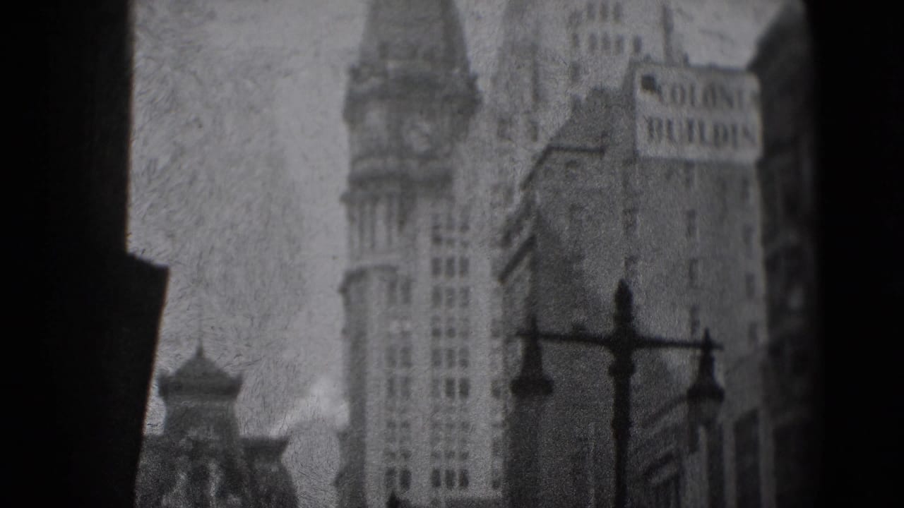 1975 Washington, DC frame with a tall towered facade, ornate street lamps, and the Colonie Building sign in a grainy street view.