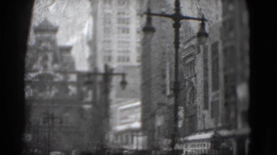 1975 Washington, DC frame with tall downtown buildings, street lamps, and dark foreground obstruction in a worn 8mm scan.
