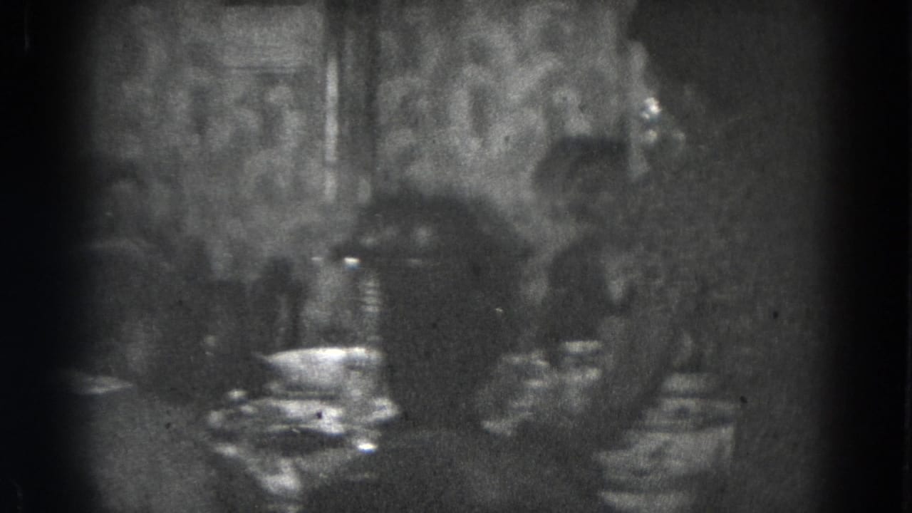Women seated around a dining table in a dim private room.